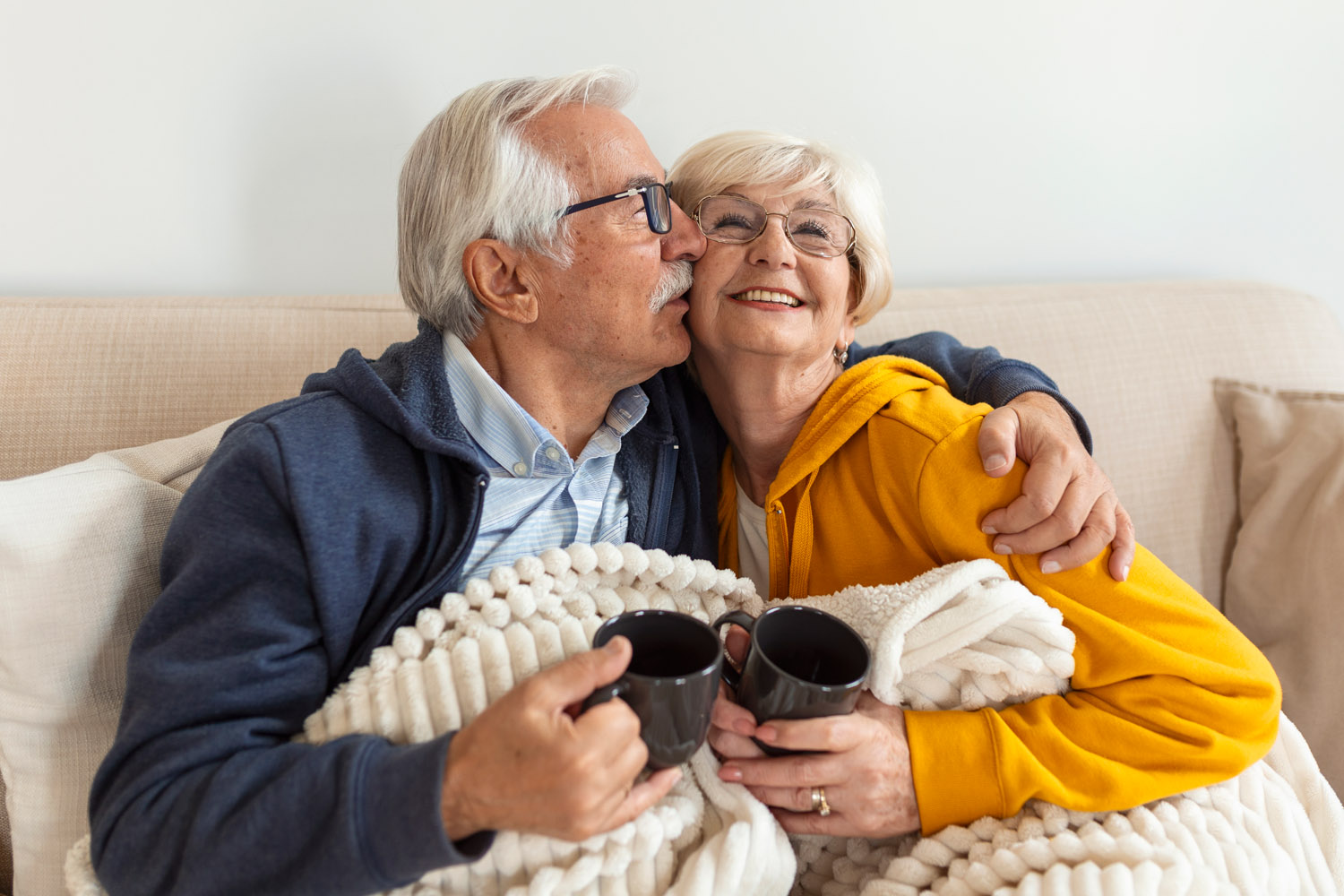Retired couple relaxing on couch